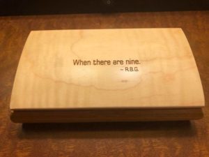 A box inscribed with the phrase, "When there are nine."