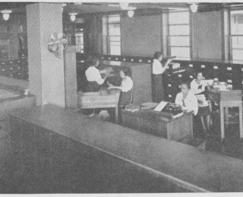 1922 Photograph of five women in a room full of filing cabinets, filing documents